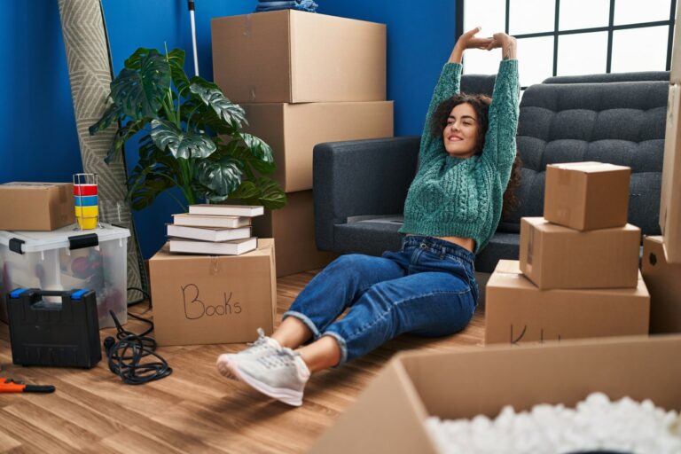 A Hispanic woman who just moved into a new home with the help of a best moving company in NYC.
